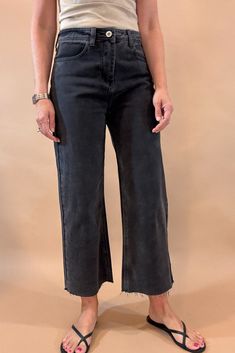 Get ready to rock the edgy chic look with these Black Crop Wide Leg Jeans. With a 23 1/2 inch seam, raw hem, slight (very slight) stretch, and distressed details, they exude effortless coolness. The lightweight denim is tapered in the back for the perfect fit, while maintaining the relaxed wide leg style. Dare to be different! Fit is true to size, Amber is modeling size small. She is 5’6”. Imported Cotton blend. Edgy Frayed Hem Jeans For Fall, Everyday Dark Wash Flare Jeans With Frayed Hem, Frayed Hem Bottoms For Fall, Black Casual Flare Jeans, Black Cropped Jeans For Work, Trendy Distressed Bottoms For Everyday, Everyday Frayed Hem Bottoms For Fall, Everyday Bottoms With Frayed Hem For Fall, Frayed Hem Bottoms For Everyday Fall Wear