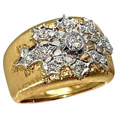 This regal, tapered diamond band was handcrafted by a family jeweler outside of Florence, Italy. Each line is hand-etched to give it a lustrous silk effect. This ring is made from solid, 18-karat yellow gold with white gold details. The shank bevels inward at the edges for a comfortable feel. Fifteen natural diamonds make up the face of the ring for an approximate carat weight of .50. The diamonds grade VS in clarity and D-F in color. The shank tapers from 13.8mm to 6.8mm and is a size 6.75. A t La Face, Florence Italy, Diamond Band, Gold Details, Diamond Bands, A Family, Florence, Band Rings, Natural Diamonds