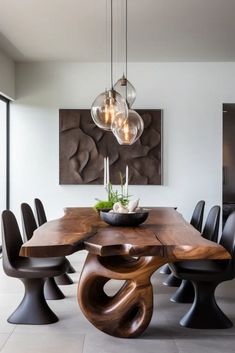 a dining room table with chairs and lights hanging from it's centerpieces