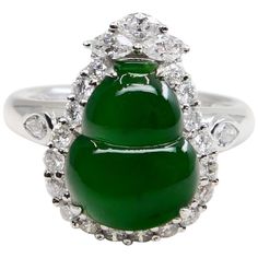 Here is an intense green Jade, very borderline true imperial jade color. This jade and diamond cocktail ring has a mystic subtle glow. It is certified by 2 labs The jade gourd represents the Fulu double, it protects people's happiness. It also means "financial resources are rolling". This vintage ring is set in 18k white gold and diamonds. We estimate the near colourless pear, marquis and round shaped diamonds in this ring setting total about 1.25 cts. The untreated / un-enhanced natural jade has a nice saturation of intense green color. This is one of those rings that you would notice across the room at a party. The ring is stunning. Not only is the green intense and dense, the subtle glow is mesmerising. Photos does not do this ring justice. A collector would want this piece for their co Jade Diamond Rings, Jade Diamond Engagement Ring, Luxury Jade Rings Fine Jewelry, Luxury Jade Rings In Fine Jewelry Style, Sugar Cookie Jade Wedding Ring, Jade Ring Crystal, Luxury Jade Wedding Ring, Luxury Polished Jade Rings, Imperial Jade