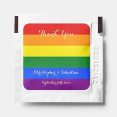 a rainbow colored napkin with the words, thank you on it and an envelope that says