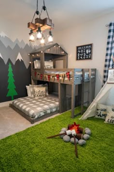 a bedroom with bunk beds and green carpeted flooring in front of a mountain mural