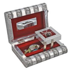 an open silver box with jewelry inside it