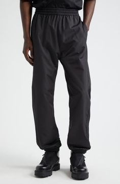 Tonal detailing keeps the look sleek and the branding subtle on these recycled-polyester track pants trimmed with piping and monogrammed with a 4G logo. 31" inseam; 10" leg opening; 13 1/2" front rise; 18" back rise (size 32) Elastic waist Front slant pockets; back welt pocket Elastic hems 100% recycled polyester Hand wash, dry flat Imported Designer Clothing Black Athleisure Pants With Logo Waistband, Welt Pocket, Bottoms Pants, Track Pants, Piping, Givenchy, Designer Clothing, Elastic Waist, Track