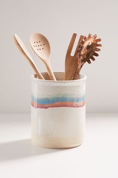 spoons and utensils in a ceramic cup