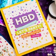 a birthday card with confetti and sprinkles on it, surrounded by other items