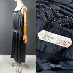 Rare haute couture evening gown by Jeanne Lanvin. Signed and dated : été 1921 JEANNE LANVIN Purchased directly from the family of the original owner, this dress is in spectacular condition for its age.  A great example of a classic flapper dress of the era. It features a drop waist, slightly gathered under a chiffon waistband. Black silk satin panels embellished with glass (or jet) beads to form an Art Deco style geometric pattern. Narrow bands of silk chiffon between the satin panels emphasise Jeanne Lanvin 1920s, Lanvin 1920s, Silk Evening Dress, Jeanne Lanvin, Antique Fabrics, Vintage Couture, Ostrich Feathers, Drop Waist, Silk Chiffon