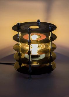 an old record player turned into a table lamp with some lights on it's sides