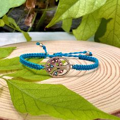 Add a touch of boho charm to your outfit with our Tree of Life Charm Macrame Bracelet. This beautifully crafted stackable friendship bracelet features a simple yet elegant design that will complement any style. Handmade using high-quality nylon thread, this bracelet is durable and comfortable to wear all day long. The Tree of Life charm symbolizes growth and strength, making it the perfect accessory for anyone looking to embrace their inner power. Whether you wear it alone or stack it with other Turquoise Bohemian Braided Bracelet For Gift, Turquoise Bohemian Braided Bracelet Gift, Adjustable Nature-inspired Bracelets, Hippie Braided Bracelet As A Gift, Adjustable Turquoise Bracelets With Nature-inspired Style, Silver Bohemian Beaded Bracelets With Macrame, Bohemian Silver Macrame Beaded Bracelets, Bohemian Braided Friendship Bracelets With Adjustable Length, Bohemian Nickel-free Friendship Bracelets As Gift