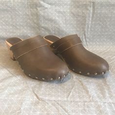 Beautiful Brown Leather Clogs With Traditional Low Wooden Base. Studded Along Edge. New Without Tags. Rugged Clogs With Round Toe And Rubber Sole, Rugged Closed Toe Clogs With Leather Footbed, Rugged Closed Toe Mules With Removable Insole, Rugged Clogs With Leather Sole And Round Toe, Rugged Closed Toe Mules With Rubber Sole, Rugged Closed Toe Mules With Leather Sole, Rugged Closed Toe Clogs With Rubber Sole, Rugged Clogs With Leather Sole, Rugged Brown Clogs With Round Toe