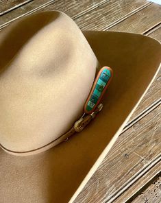 Put a unique rustic twist on your look with this one-of-a-kind Turquoise Chunks Leather Hat Pick by McIntire Saddlery. This hand tooled and hand painted hat pick features a gorgeous turquoise chunks design that is sure to make you stand out from the crowd. So, grab this pick and show off your style! Features: Hand tooled leather Turquoise Stone Chunk design Hand Painted Measures: Southwestern Turquoise Hat Bands For Country Events, Southwestern Turquoise Hat Band For Ranch, Artisan Hand Painted Adjustable Hat Bands, Southwestern Turquoise Hat For Ranch, Southwestern Style Turquoise Hat For Ranch, Artisan Turquoise Hats For Western-themed Events, Artisan Turquoise Hat For Western-themed Events, Handmade Southwestern Turquoise Hat Bands, Handmade Southwestern Blue Hat