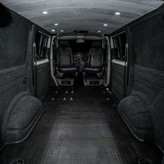 the interior of an empty van with seats up and two rear doors open on both sides