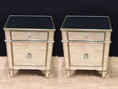 two gold and black nightstands side by side on wooden floor with dark wall in background