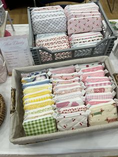 several different types of quilts are on display at a showroom for sale in baskets