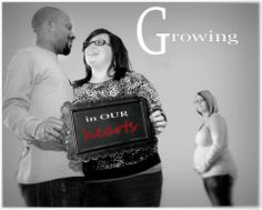 a man and woman holding a sign that says growing in our hearty on it