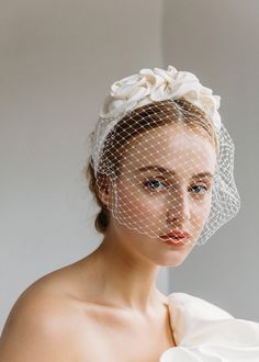 a woman wearing a veil with flowers on it