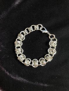 This stainless steel chainmaille bracelet is hand woven using 100% stainless steel rings. Stainless is hypoallergenic, strong, non-corrosive and very long lasting with easy maintenance.  Stainless does not tarnish or rust, making it perfect for continuous wear. It's also perfect for those with sensitivities to nickel.  This bracelet matches with our CAPHZIEL Necklace.  MEASURES  7'.5" Inches (adjustable to 9'')   19 cm (adjustable to 22.'5 cm)  THIS ITEM IS MADE TO ORDER   Expect 4-6 weeks before shipping. You will essentially be skipping the line, without having to wait for scheduled restocks that may sell out.  If you need a custom size, please include your measurements in the notes.  Handmade Disclaimer   Each piece is handmade by me. Therefore there may be slight, nearly undetectable d Silver Chainmail Chain Link Bracelets, Silver Chainmail Bracelet With Chain Link, Silver Chain Bracelet With Jump Ring, Silver Chainmail Stainless Steel Chain Bracelet, Silver Stainless Steel Chainmail Bracelet, Silver Chainmail Bracelet As A Gift, Silver Chainmail Chain Bracelet As Gift, Chainmail Bracelet, Chainmaille Bracelet