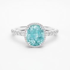 ITEM INFORMATION Gemstone:  * Paraiba Tourmaline & Diamond Paraiba Tourmaline:  * Weight: 1.50 carats * Cut: Oval Diamonds:  * Grade: G / VS-VVS Metal: * 18K White Gold * Platinum 950 Ring Dimensions: * 9x7mm (Including diamond halo) Also available in: * Different Dimensions & Gemstones * 18K Yellow Gold & 18K Rose Gold Certification: * Complimentary certificate of authenticity * Complimentary GIA or GRS certification (All our gemstones and metals are responsibly mined and traceable to their sou White Gold Tourmaline Ring With Accent Stones, Luxury Tourmaline Rings With Halo Setting, Gia Certified Oval Aquamarine Jewelry, Gia Certified Tourmaline Jewelry For Anniversary, Gia Certified Tourmaline Wedding Ring, Fine Jewelry Tourmaline Rings With Brilliant Cut, Oval Tourmaline Gemstones With Accent Stones, Wedding Gia Certified Tourmaline Ring, Tourmaline Jewelry With Halo Setting For Anniversary