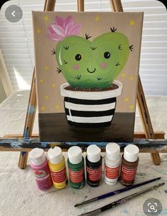 a painting of a cactus in a striped pot with paint and acrylic paints