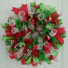 a christmas wreath with green, red and white bows