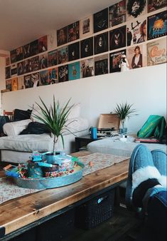 a living room filled with furniture and lots of pictures on the wall above it's coffee table