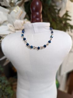 Classy blue crystal and silver necklace. Sparkly all the way around! Will look fabulous with your doll's cocktail dress or evening gown. Blue crystal beads on silver metal rings. Nickel-free. Lobster claw closure. Made for 18-inch dolls. Blue Necklace With Lobster Clasp For Party, Handmade Blue Crystal Necklace For Party, Sapphire Nickel-free Jewelry For Party, Nickel-free Sapphire Jewelry For Party, Blue Beaded Evening Jewelry, Blue Beaded Jewelry For Evening, Blue Beaded Necklaces For Evening, Blue Crystal Necklaces For Jewelry Making, Blue Metal Crystal Necklaces For Jewelry Making