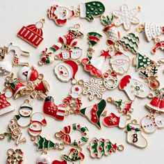 a pile of assorted christmas decorations on a white surface with lots of them in the middle