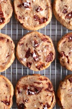 chocolate chip cookies cooling on a wire rack with coconut flakes all over them,