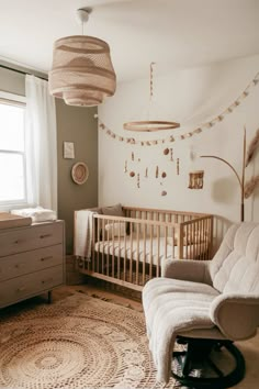 a baby's room with a crib, rocking chair and dresser in it