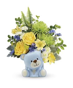 a blue teddy bear with yellow and white flowers