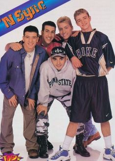 a group of young men standing next to each other in front of a poster for the movie high school musical