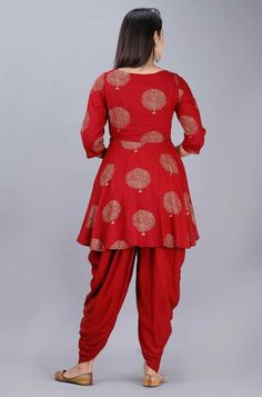 Handcrafted with absolute perfection, this Kurti with Dhoti pants set is perfect for small festive occasions. The fabric used is rayon and is very soft and comfortable to wear all day long. The Kurti has a peplum style with foil print all over. Fabric: Rayon Sizes: Garment measurement: Bust (in inches): S(36), M(38), L(40), XL(42), 2XL(44), 3XL(46), 4XL(48), 5XL(50) Choose garment measurement 2 inches more than your body bust measurement Print: Foil Print Wash care: Dry Clean Dispatch within 7 d Bollywood Style Red Pant Set For Diwali, Red Bollywood Pant Set For Diwali, Traditional Red Pant Set For Navratri, Bohemian Pant Set For Navratri Festival, Festive Harem Kurta For Eid, Festive Eid Harem Kurta, Anarkali Pant Set For Navratri, Traditional Drape Pant Set For Navratri, Traditional Drape Pant Set For Navratri Festivities