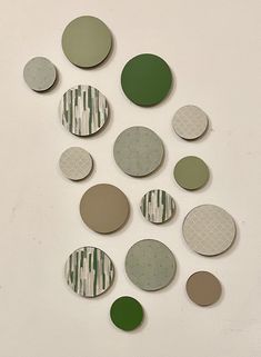 several circles are arranged on the wall with green and white stripes around them, as if they were made out of paper