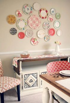 a dining room table with plates on the wall