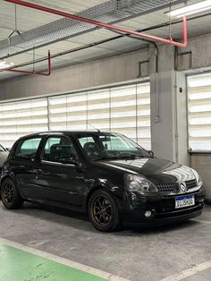 two cars parked in a parking garage next to each other