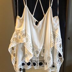 White With Multiple Spaghetti Straps And Adjustable Straps. Detailed Around The Bottom. No Tags But Never Worn Chic Camisole For Beach Season Vacation, Flowy White Top For Beach Cover-up, Chic Camisole For Beach Vacation, Chic Camisole Top For Beach Season, White Summer Beach Camisole, White Summer Vacation Camisole, Summer Beach Cami Top, Chic Flowy Top For Beach Cover-up, Chic Camisole Blouse For The Beach