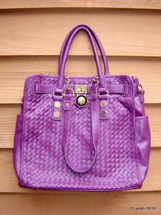 PURPLE LEATHER WEAVE SEGOLENE PARIS limited past usage clean outside and inside Nominal past usage. Clean condition one stray mark near bottom. A Parisian designer purse. Body is purple leather. Signature inside fabric lining. Front is embellished with faux padlock. Has both handles and chain leather strap a beautiful handbag, indeed!. Three outer pockets 2 are on the ends. 4 inside pockets one is cavernous the other three are side pockets and one is a zippered. zipper closure. 13 by 14 by 5 by Luxury Purple Bags With Palladium Hardware, Luxury Purple Leather Satchel, Designer Purple Bags With Silver-tone Hardware, Designer Purple Bags With Gold-tone Hardware, Designer Purple Bag With Silver-tone Hardware, Large Handbags, Leather Weaving, Beautiful Handbags, Purple Leather