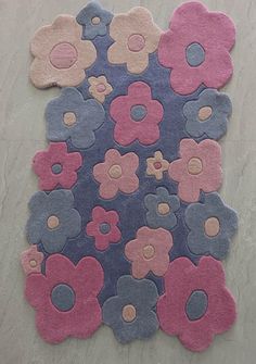 an area rug with various colored flowers on top of it and two circles in the middle