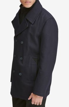 A hearty wool blend enriches a classic peacoat with a smart internal bib for added warmth and protection. 33" length Double-breasted button closure Notched lapels Side welt pockets Lined, with 100% polyester fill 46% wool, 40% polyester, 5% acrylic, 4% nylon, 3% rayon, 2% cotton Dry clean Imported Men's Clothing Winter Navy Blazer With Double-breasted Buttons, Winter Navy Double-breasted Blazer, Navy Double-breasted Blazer For Winter, Navy Double-breasted Blazer For Fall, Fitted Double-breasted Collared Outerwear, Fitted Collared Double-breasted Outerwear, Collared Pea Coat For Winter, Black Double-breasted Wool Peacoat, Black Wool Double-breasted Peacoat