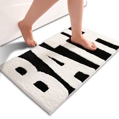 a person is standing on a bath mat