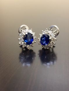 DeKara Designs Collection Metal- 90% Platinum, 10% Iridium. Stones- 2 Oval Shaped Ceylon Blue Sapphires 1.20 Carat each, 24 Round Diamonds G Color VS2 Clarity, 1.05 Carats. Beautiful Art Deco Inspired Handmade Platinum Ceylon Blue Sapphire Diamond Halo Earrings. The entire earrings are hand assembled, the back of the earrings are made in 90% platinum. The sapphires are sitting in between 4 prongs, and the diamonds are surrounding them and prong set as well. The sapphires are perfectly matching i Gia Certified Sapphire Earrings For Formal Occasions, Elegant Blue Gia Certified Diamond Earrings, Gia Certified Sapphire Diamond Earrings For Formal Occasions, Formal Gia Certified Sapphire Diamond Earrings, Formal Oval Sapphire Diamond Earrings, Formal Gia Certified Oval Earrings, Formal Sapphire Diamond Oval Earrings, Luxury Oval Cluster Earrings For Formal Occasions, Blue Round Cluster Earrings For Formal Occasions