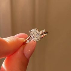 a person holding a diamond ring in their hand