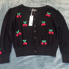 Women’s Button Up Sweater Black With Red Cherries Brand New With Tags Size M No Returns Black Buttoned Spring Sweater, Black Buttoned Sweater For Spring, Trendy Black Sweater With Button Closure, Black Retro Cotton Cardigan, Black Fitted Button Sweater, Black Cotton Cardigan With Buttons, Vintage Black Cardigan With Button Closure, Vintage Black Sweater With Buttons, Cherry Sweater