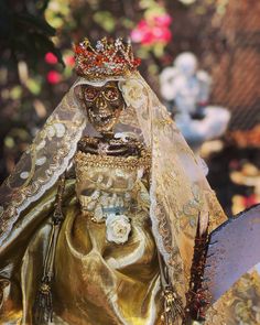 a statue of a woman wearing a gold dress and tiara