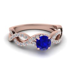 a rose gold ring with an oval blue sapphire surrounded by diamonds