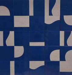 a blue and white tiled wall with different shapes