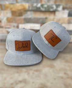 *Each hat sold separately* Our adjustable snapback hat set can be a perfect gift for a new dad, dad to be,  father and son or even siblings. Our personalized hats are made-to-order by picking one of our colorful leatherette patches to be engraved with a name or initials. We recommend hand wash/ spot clean only and then let air dry. SIZING  All our hats are adjustable snapbacks, sizing is approximate. Infant size 45-50cm (6months- 3 years) Kids size 50-55cm (4 years- 8 years) Adults(55.8-60.6 cm) HOW TO ORDER  1-Pick hat size/color  2-pick patch color 3-Enter customization in the personalization box *Name may have different sizing due to variation of font chosen. preview upon request* RETURN POLICY We are unable to accept returns on personalized items. Please make sure your personalization Adjustable Gray Hat For Gift, Adjustable Flat Brim Hats As Gifts, Adjustable Flat Brim Hats As Gift, Adjustable Flat Brim Hat As Gift, Adjustable Snapback Hat With Curved Brim For Father's Day, Flat Bill Hats For Father's Day Gift, Customizable Flat Bill Snapback Hat As Gift, Gift Flat Bill Baseball Cap One Size, Adjustable Curved Brim Snapback Hat For Birthday