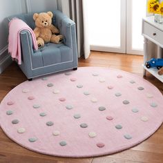 a teddy bear sitting in a chair next to a pink rug