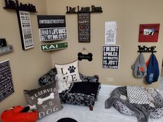 a dog themed room with lots of signs on the wall and furniture in front of it