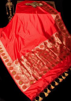 The charming-hued Red Banarasi Katan Silk Saree with a fancy Meenakari Border and Pallu looks just as delightful as it is in the pictures. It's a perfect blend of sophistication and heritage.  The smooth Katan silk material ensures both comfort and luxuriousness. The detailed color blocking adds a touch of royalty to this saree, while the enchanting Meenakari Zari Border brings out its feminine and graceful side.  SILK MARK CERTIFIED This saree is ready to wear with fall and pico done. Handmade silk tassels adorn the pallu and add more grace to it. An unstitched blouse fabric is included. *Note: There may be minor variations in the shade, the texture of the product. Hues/textures show differently due to variations in screen settings and other factors, *Note: This is a handwoven saree and t Banarasi Katan Silk Saree, Silk Banarasi Saree, Silk Tassels, Katan Silk Saree, Katan Silk, Banarasi Saree, Silk Material, Banarasi Sarees, Blouse Fabric